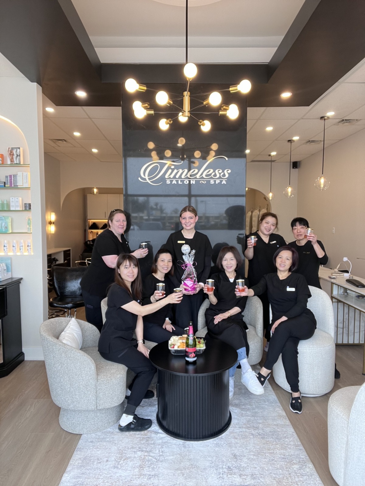 The Timeless Salon & Spa team toasting in the salon